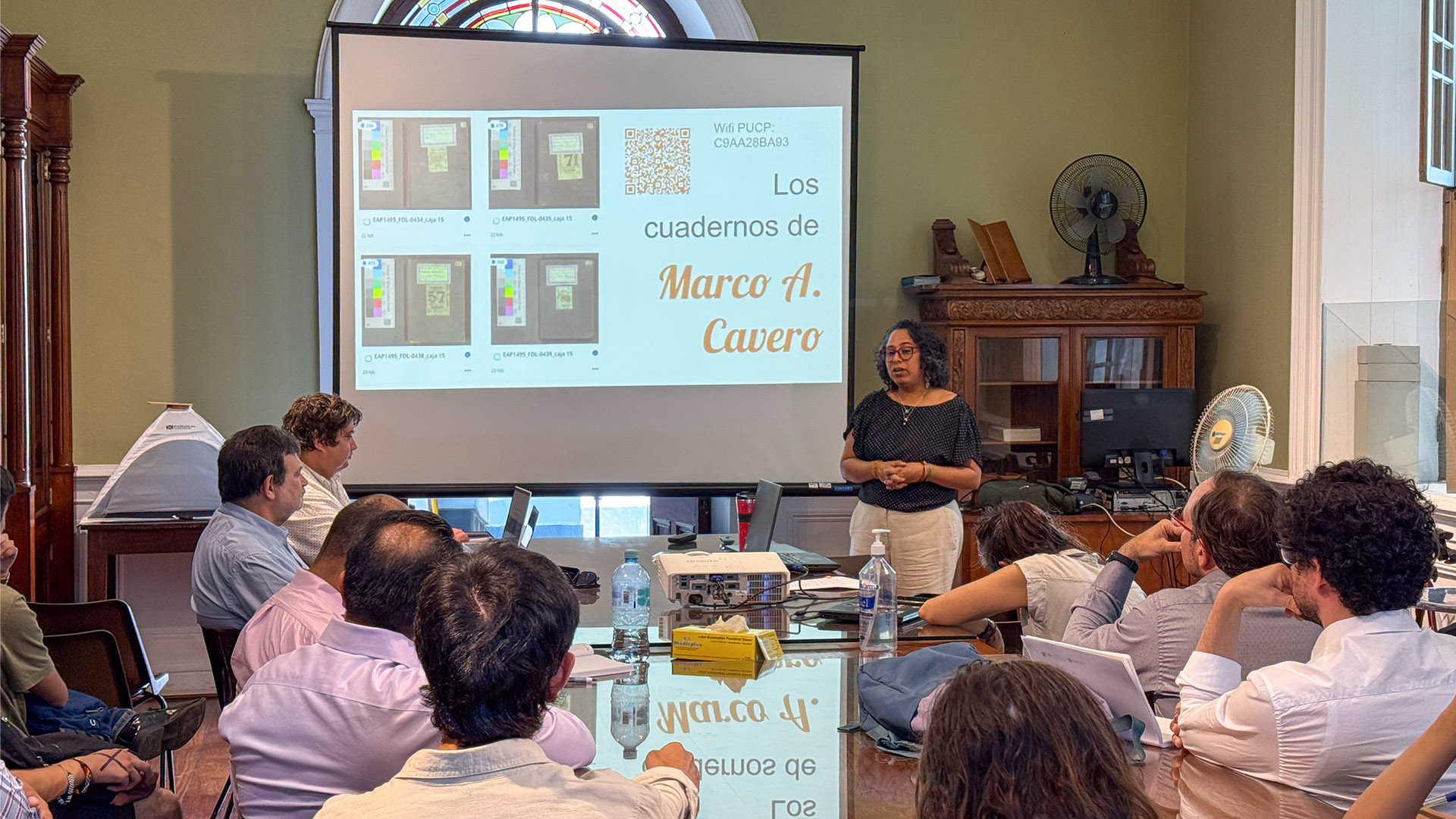 La Dra. Magally Alegre se para frente a los alumnos y profesores en una de los salones de la Casa O'Higggins.